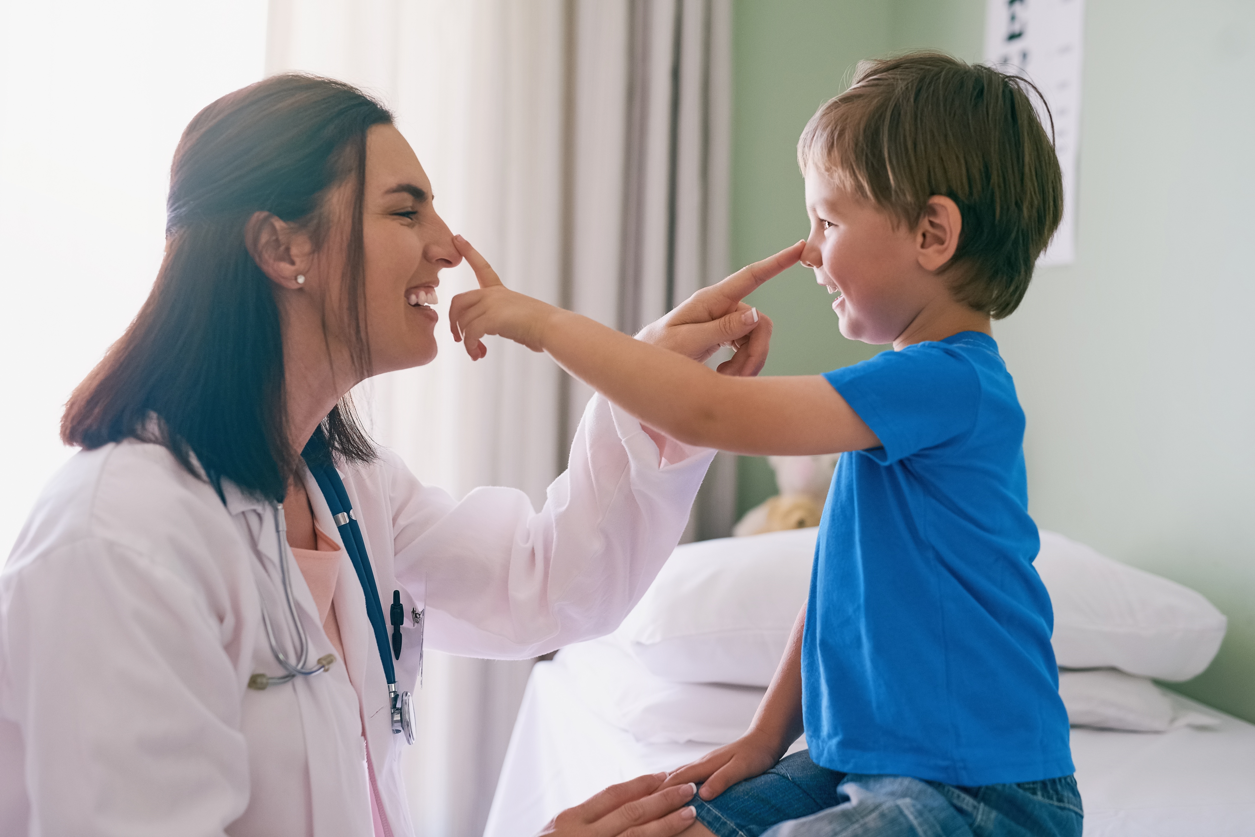 Smiling doctor with a child patient